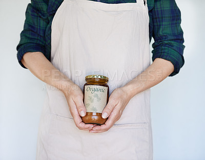 Buy stock photo Person, product and hands with organic jam for biodiversity,  sustainability and eco friendly in home. Preserver, apron and natural fruit spread for health, quality and wellness on white background