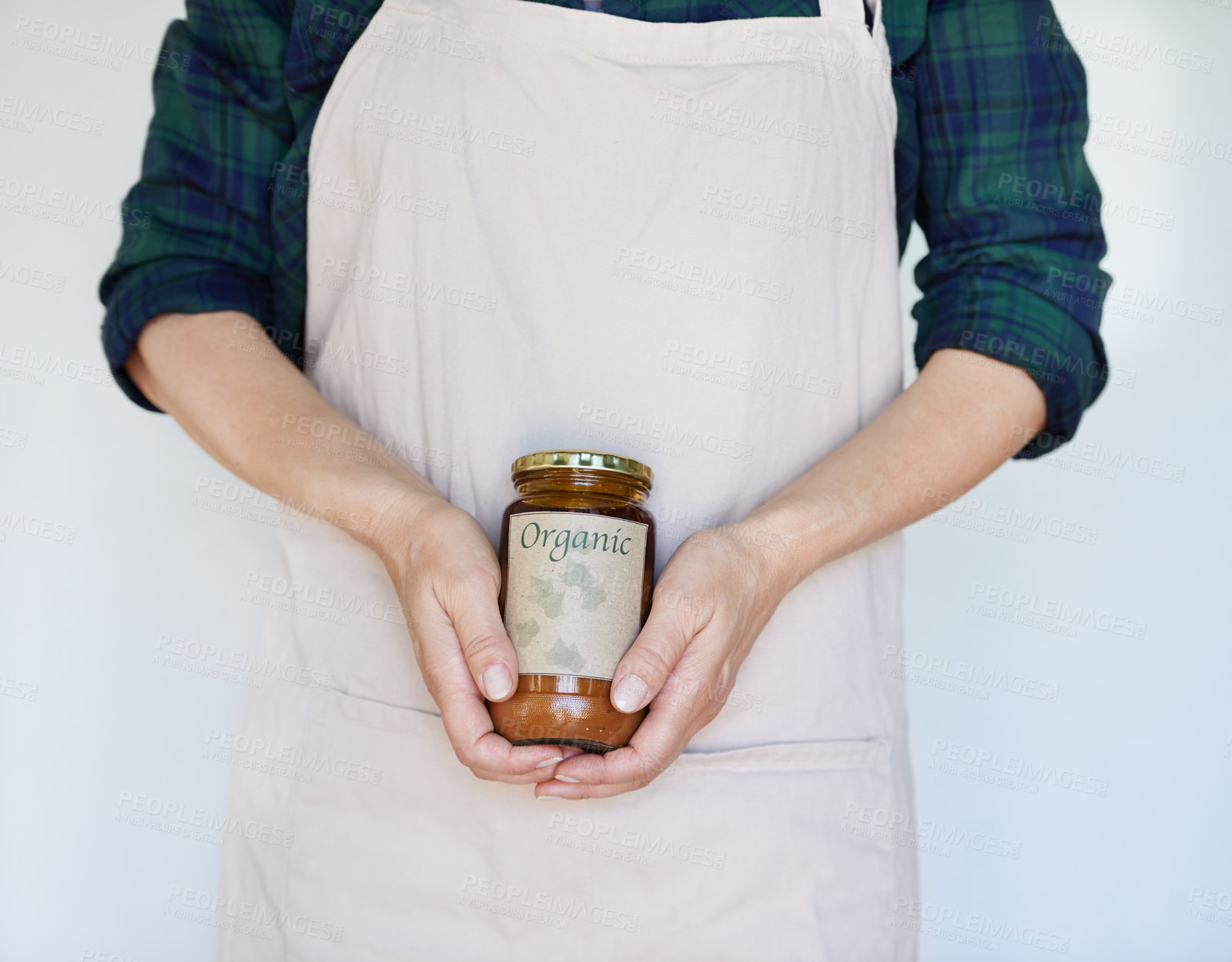 Buy stock photo Person, product and hands with organic jam for biodiversity,  sustainability and eco friendly in home. Preserver, apron and natural fruit spread for health, quality and wellness on white background