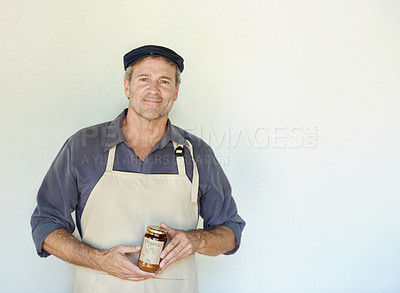 Buy stock photo Cropped shot of a person holding a jar of freshly made jam