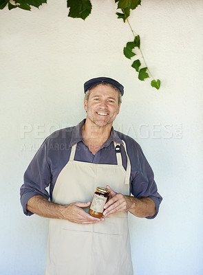 Buy stock photo Cropped shot of a person holding a jar of freshly made jam