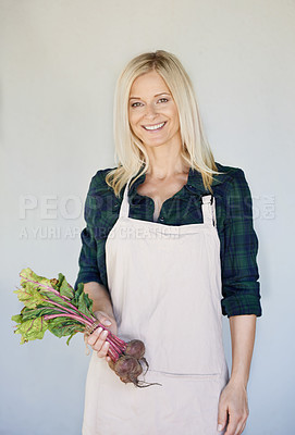 Buy stock photo A woman holding a bunch of beetroot