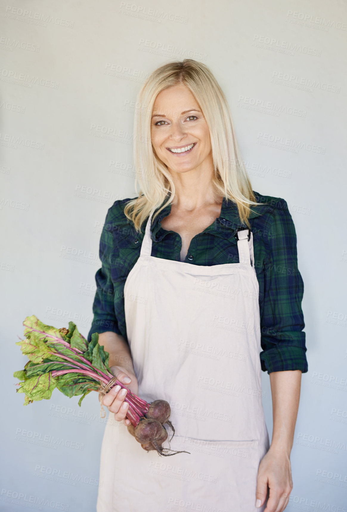 Buy stock photo Farmer, vegetables and portrait of woman with onions for agriculture, harvest or organic food by wall. Growth, fresh produce and person with apron for agro business, gardening or sustainability