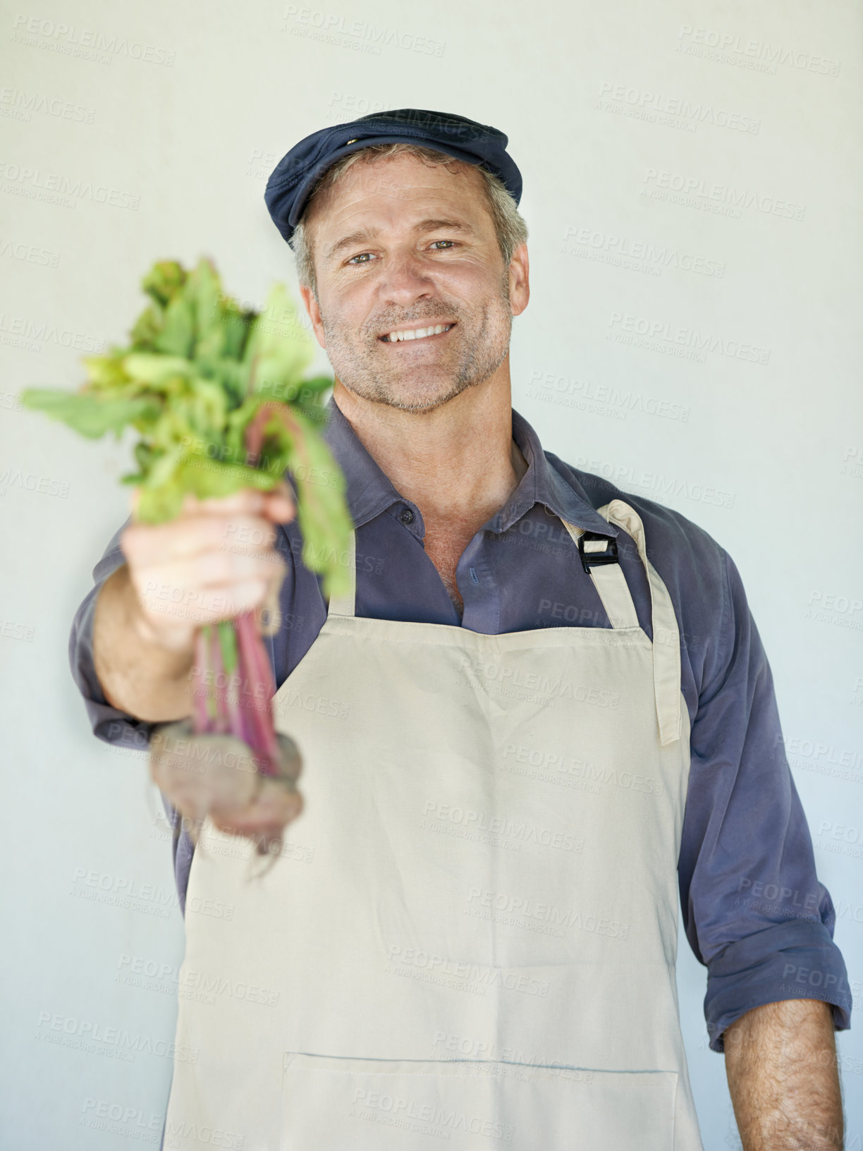 Buy stock photo Farming, fresh and portrait of man with vegetables for agriculture, harvest or organic produce by wall. Growth, cultivation and male person with apron for agro business, gardening or sustainability