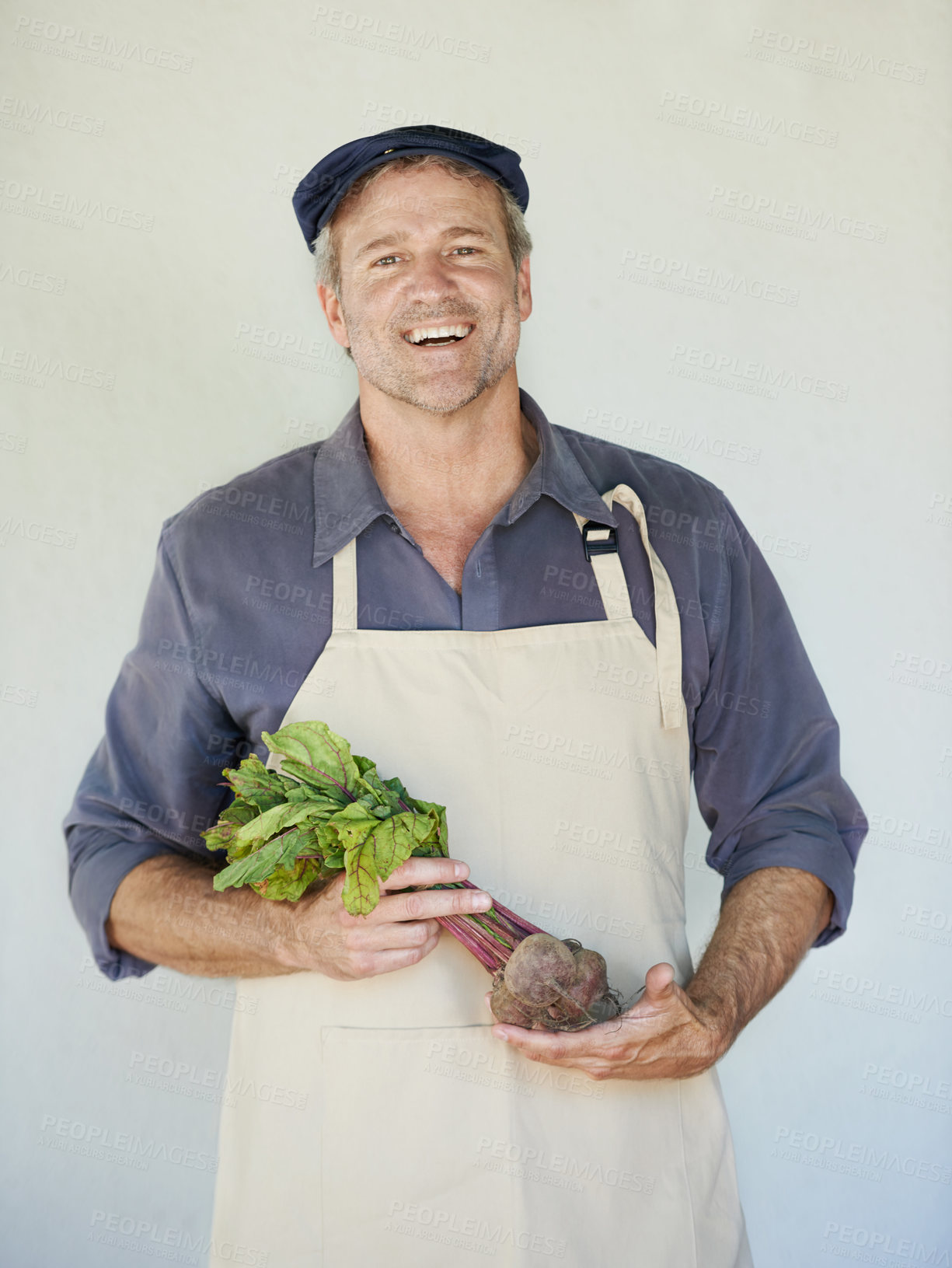 Buy stock photo A mature man holding a bunch of beetroot