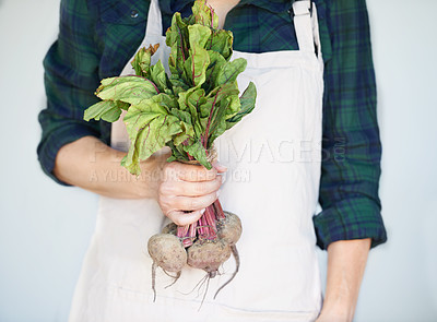 Buy stock photo A woman holding a bunch of beetroot