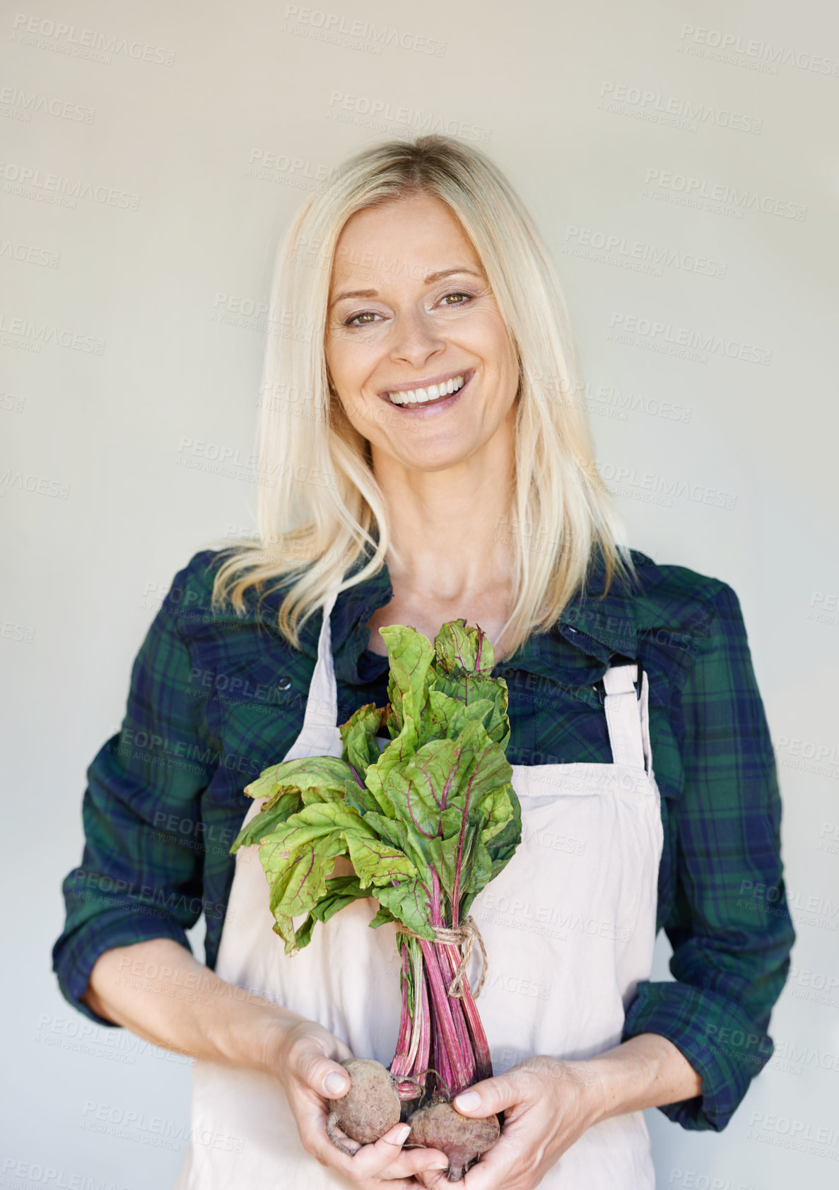 Buy stock photo A woman holding a bunch of beetroot