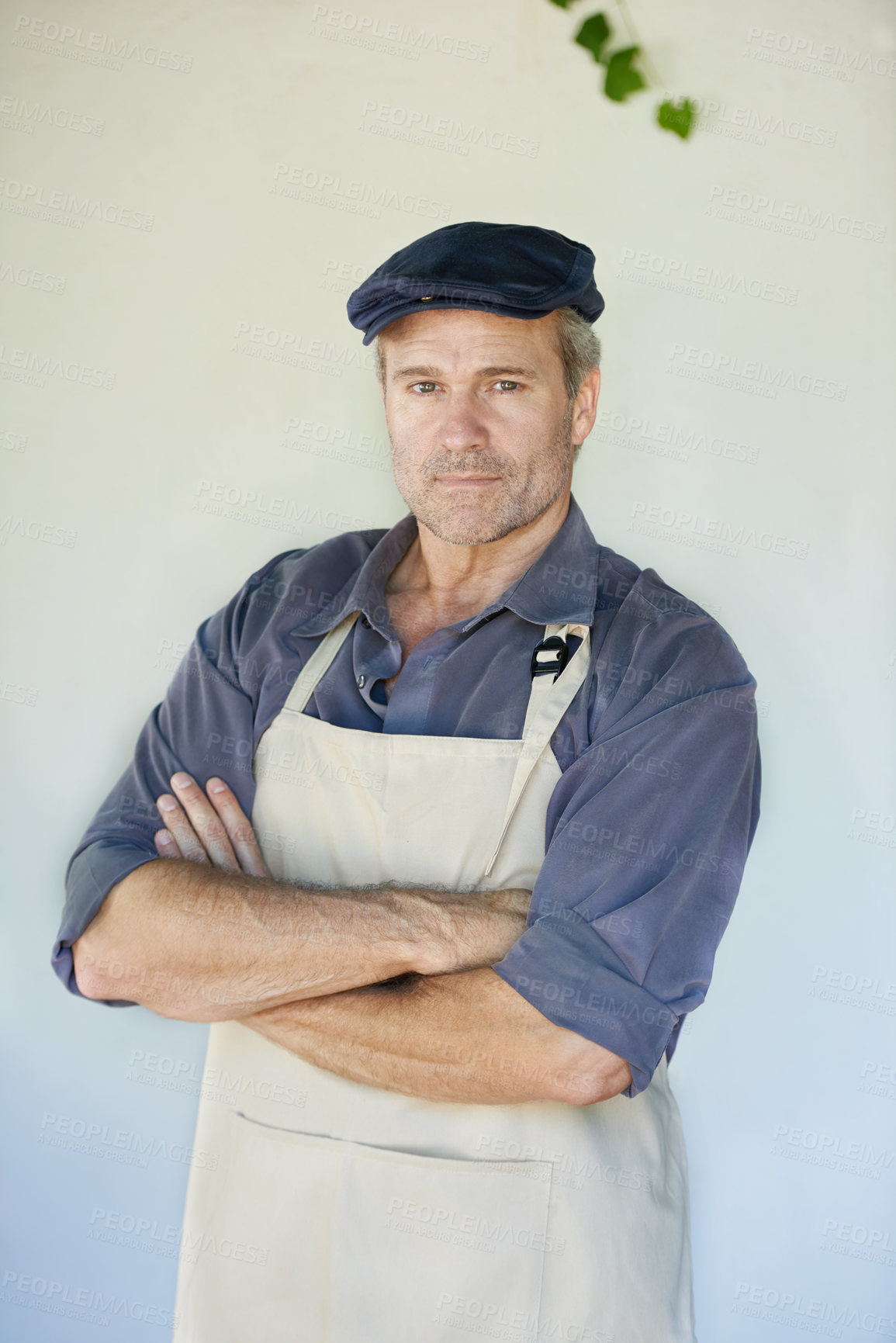 Buy stock photo Portrait, man and confident cafe owner on wall background for small business startup manager. Face, entrepreneur or mature professional with arms crossed in apron at restaurant for barista in Germany