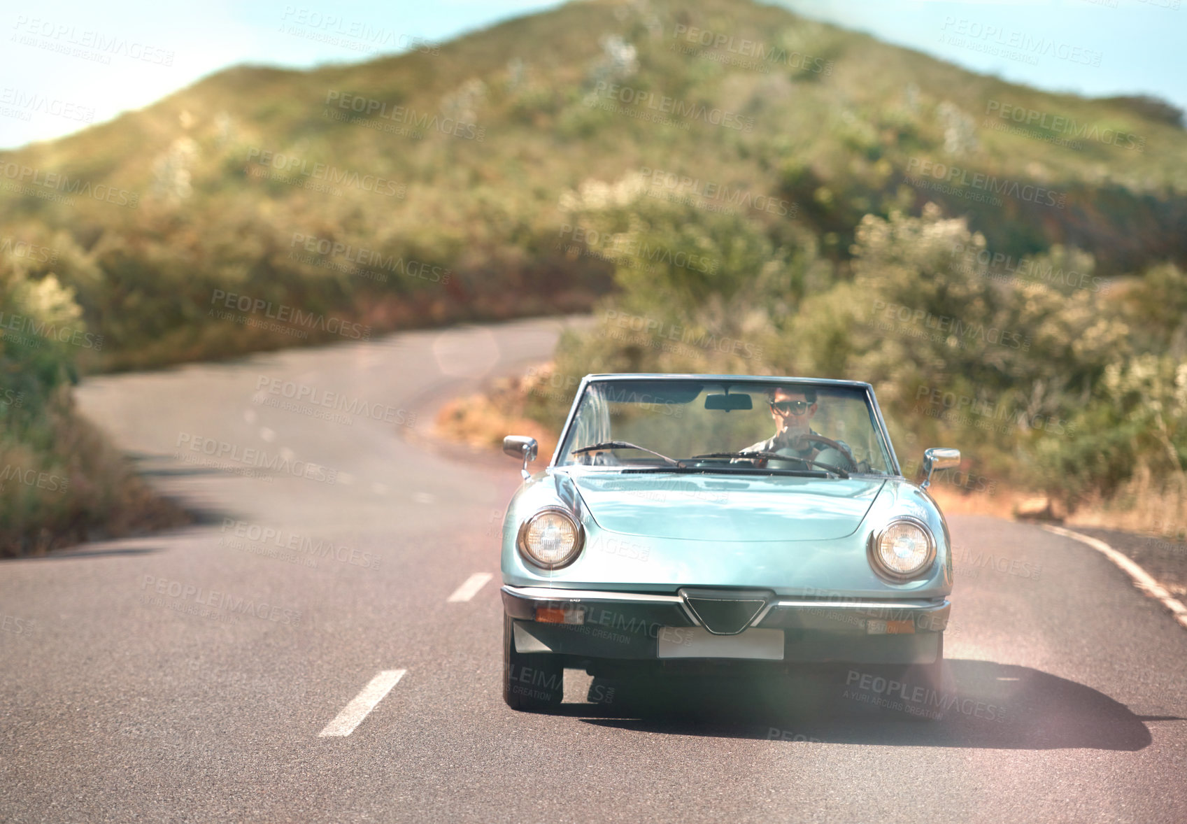 Buy stock photo Asphalt, road trip and man in convertible car with driving for travel, solo holiday journey and sunshine. Countryside, outdoor and guy in motor for vacation with explore and summer adventure in Italy