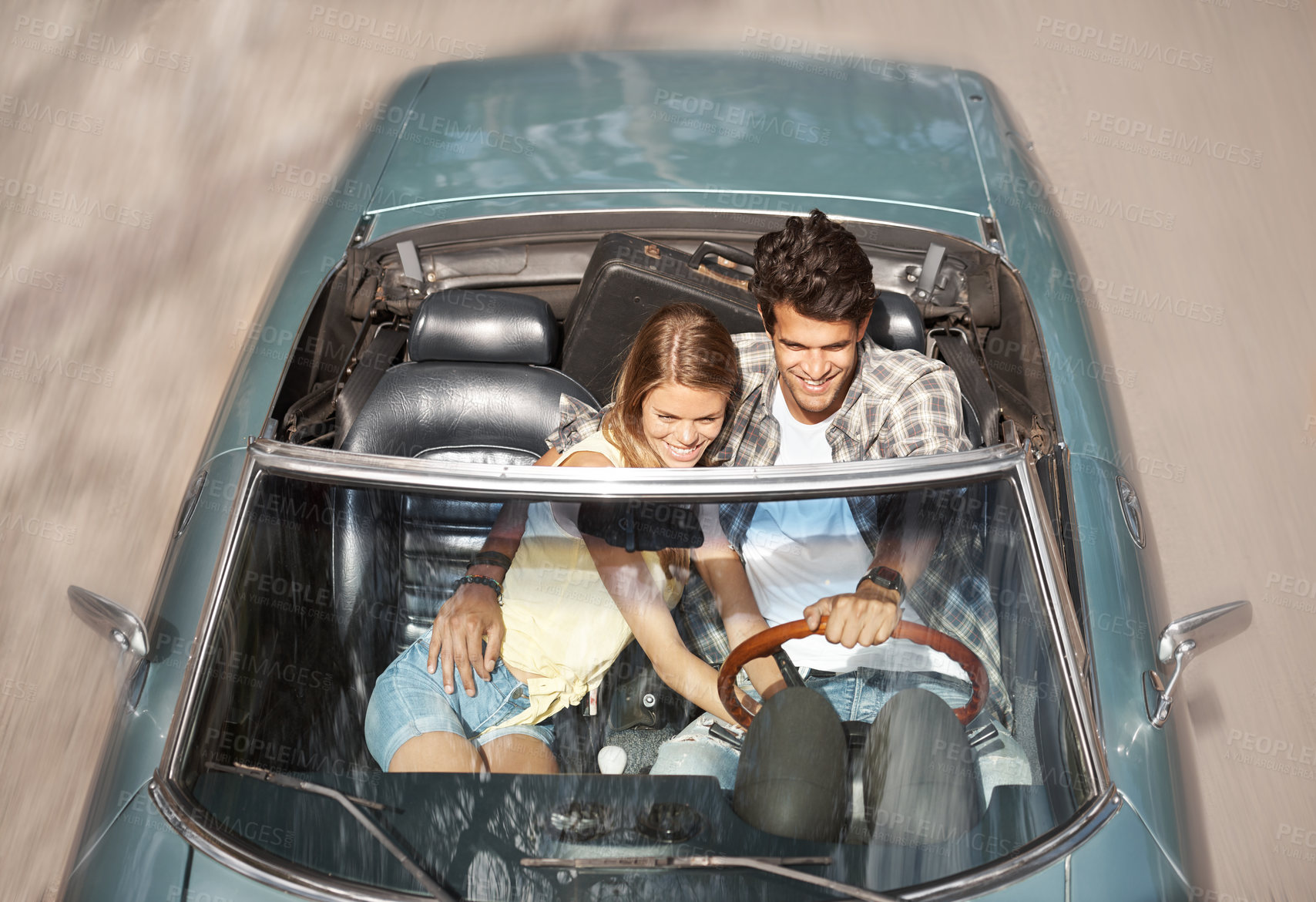 Buy stock photo Happy, couple and driving sports car on road trip, holiday or above highway on vacation adventure. Luxury, travel and people hug with love in convertible on journey in summer with transportation