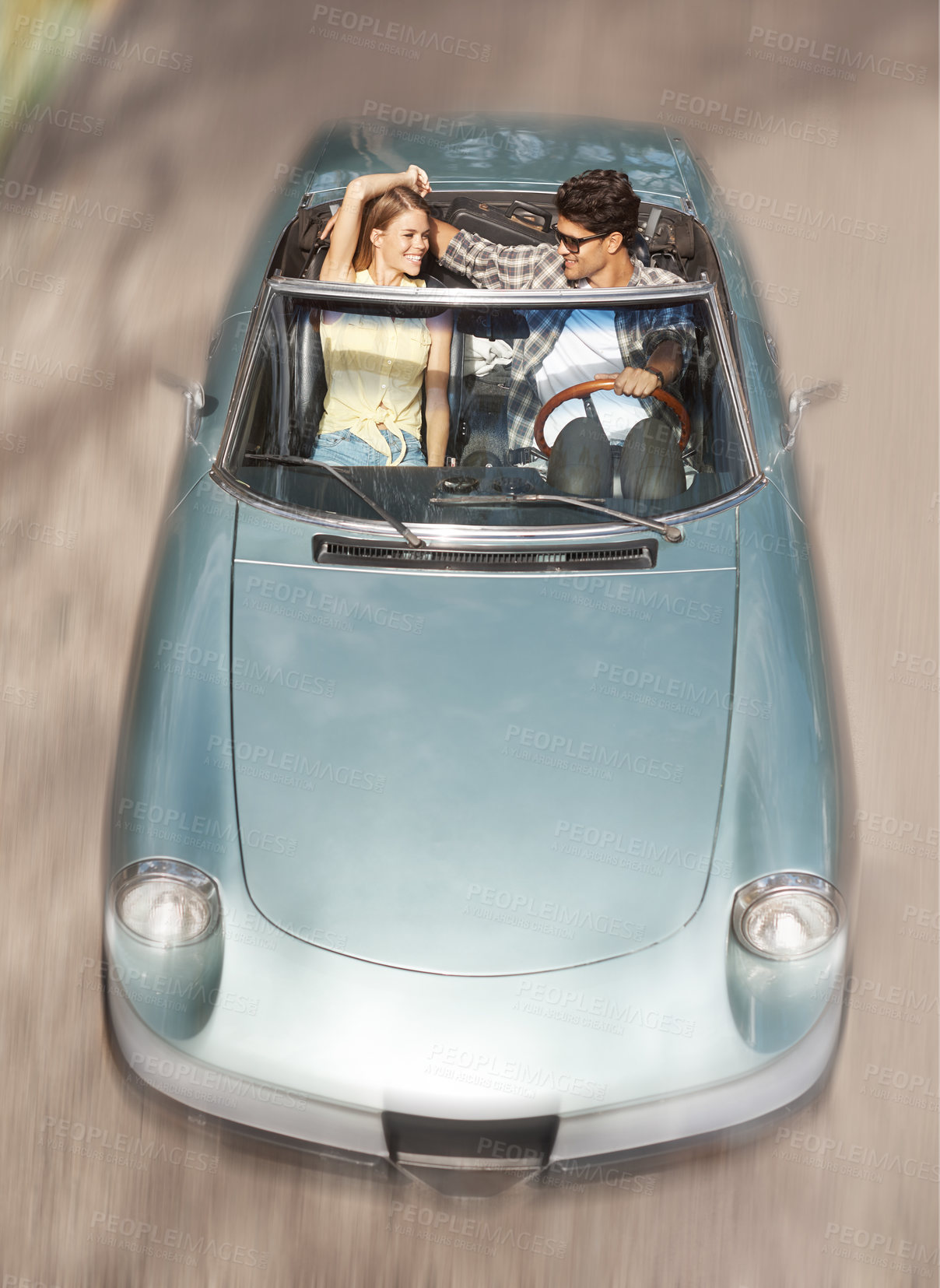 Buy stock photo Road trip, top view and couple in convertible car for travel with speed, holiday lo e and honeymoon for happy marriage. Movement, man and woman in motor for vacation together and relationship journey