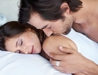 Buy stock photo Woman, sleeping and man in bed for kiss, love and affection for communication in home. Couple, dreaming and touch for connection in marriage, relationship and care for security or dream of romance