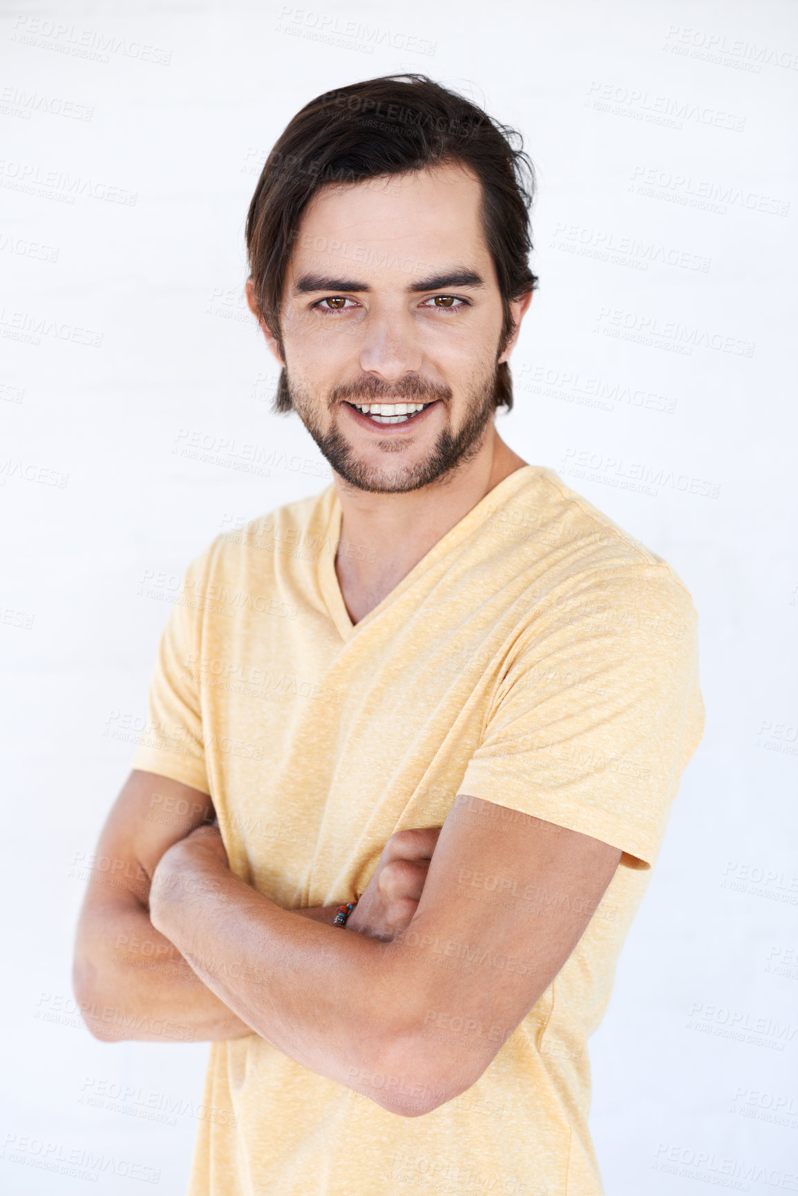 Buy stock photo Happy, man and portrait of a model with casual tshirt and vertical white background. Isolated, arms crossed and person smiling and feeling positive with happiness alone and comfortable fashion