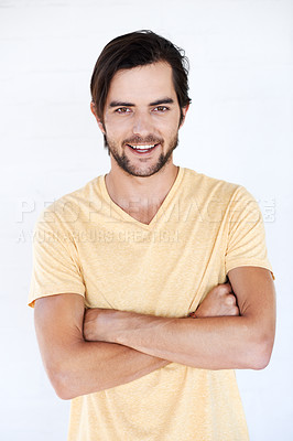 Buy stock photo Happy, smile and portrait of a man with casual fashion and tshirt with vertical white background. Isolated, arms crossed and model smiling and feeling positive with joy alone looking comfortable