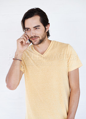 Buy stock photo Man, phone and phone call in studio, happy and relax while standing against white background space. Young, handsome and casual guy enjoying call, conversation and speaking while chilling and isolated