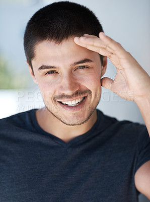 Buy stock photo Handsome young man giving you a smile while looking at the camera