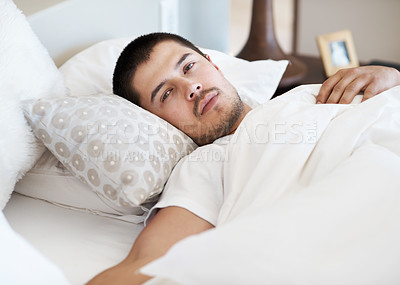 Buy stock photo Handsome man lying in bed after waking up in the morning