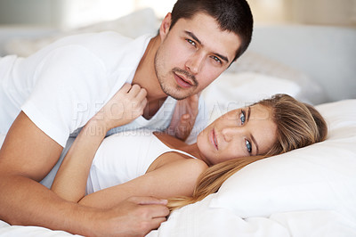 Buy stock photo Affectionate young couple lying together