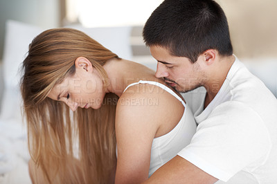 Buy stock photo Hug, woman and man in bed with kiss for love, affection or relax together in bedroom. Calm, comfort and married couple with embrace for wake up, romantic relationship or bonding on weekend in home