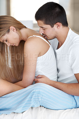 Buy stock photo Young man romantically kissing his partner as she sits in front of him