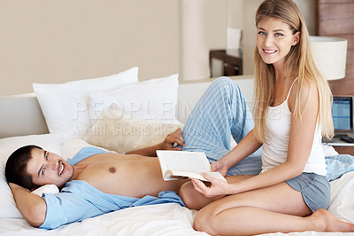 Buy stock photo Couple, book and reading in bed, portrait and relax with literature, smile and care for connection. Woman, man and happy with novel, poetry and together in bedroom with story in morning at apartment