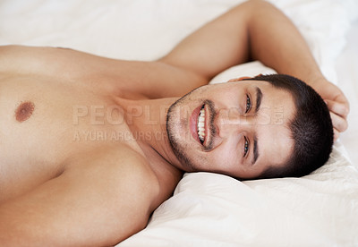 Buy stock photo Handsome young man lying in his bed while shirtless