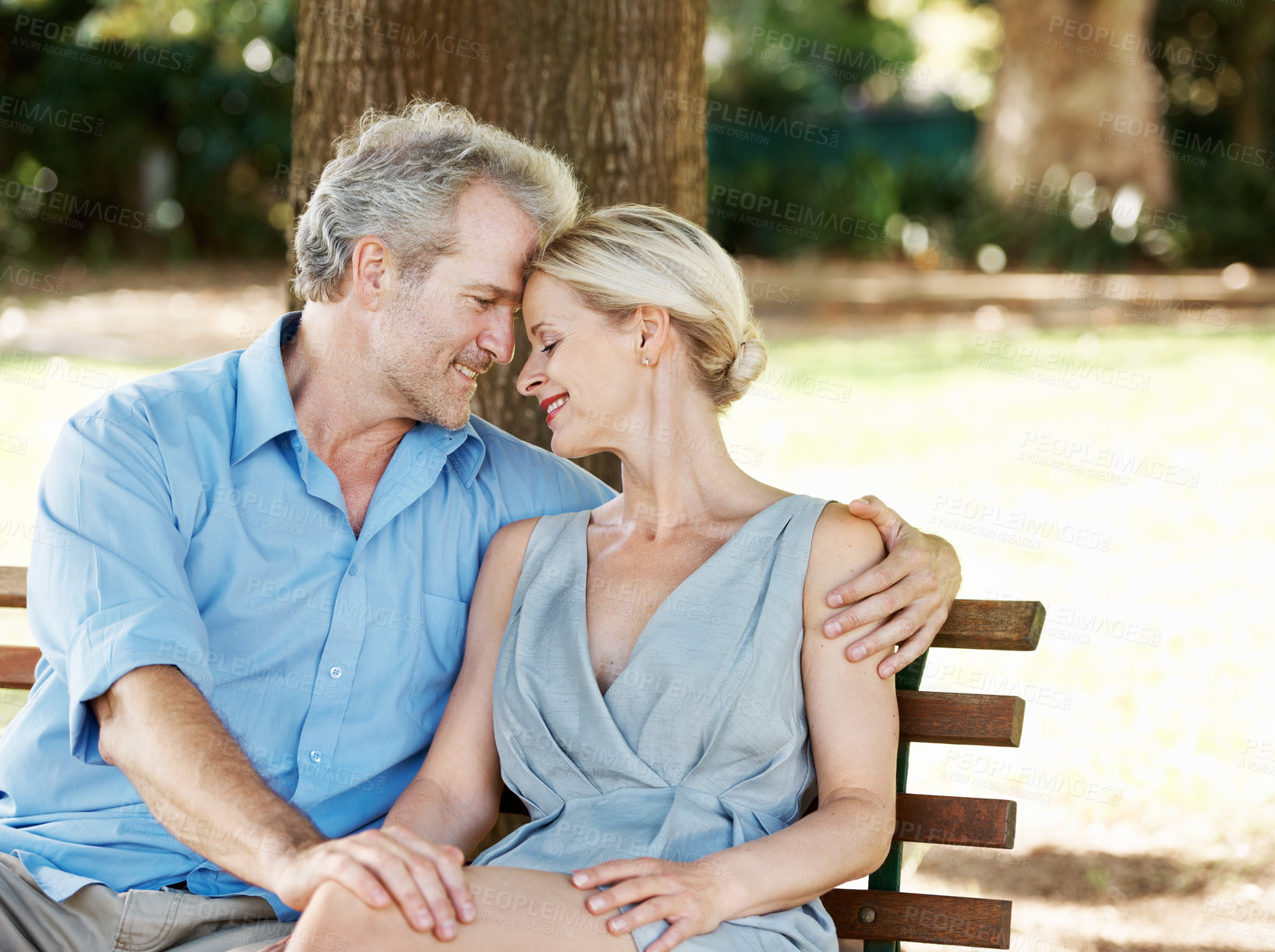 Buy stock photo Mature, happy couple and hug with embrace on bench, outdoor and relax with together in commitment. Woman, man and anniversary with love on date, vacation or holiday in France for calm, peace and zen