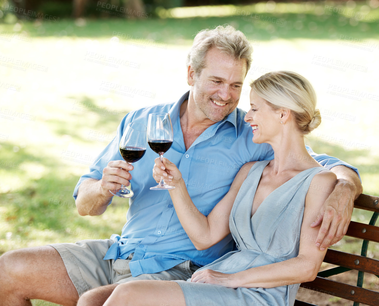 Buy stock photo Happy, couple mature and wine toast on bench, outdoor or relax for celebration on vineyard estate. Woman, man or anniversary with cheers on date, vacation or holiday in France for calm, peace or zen
