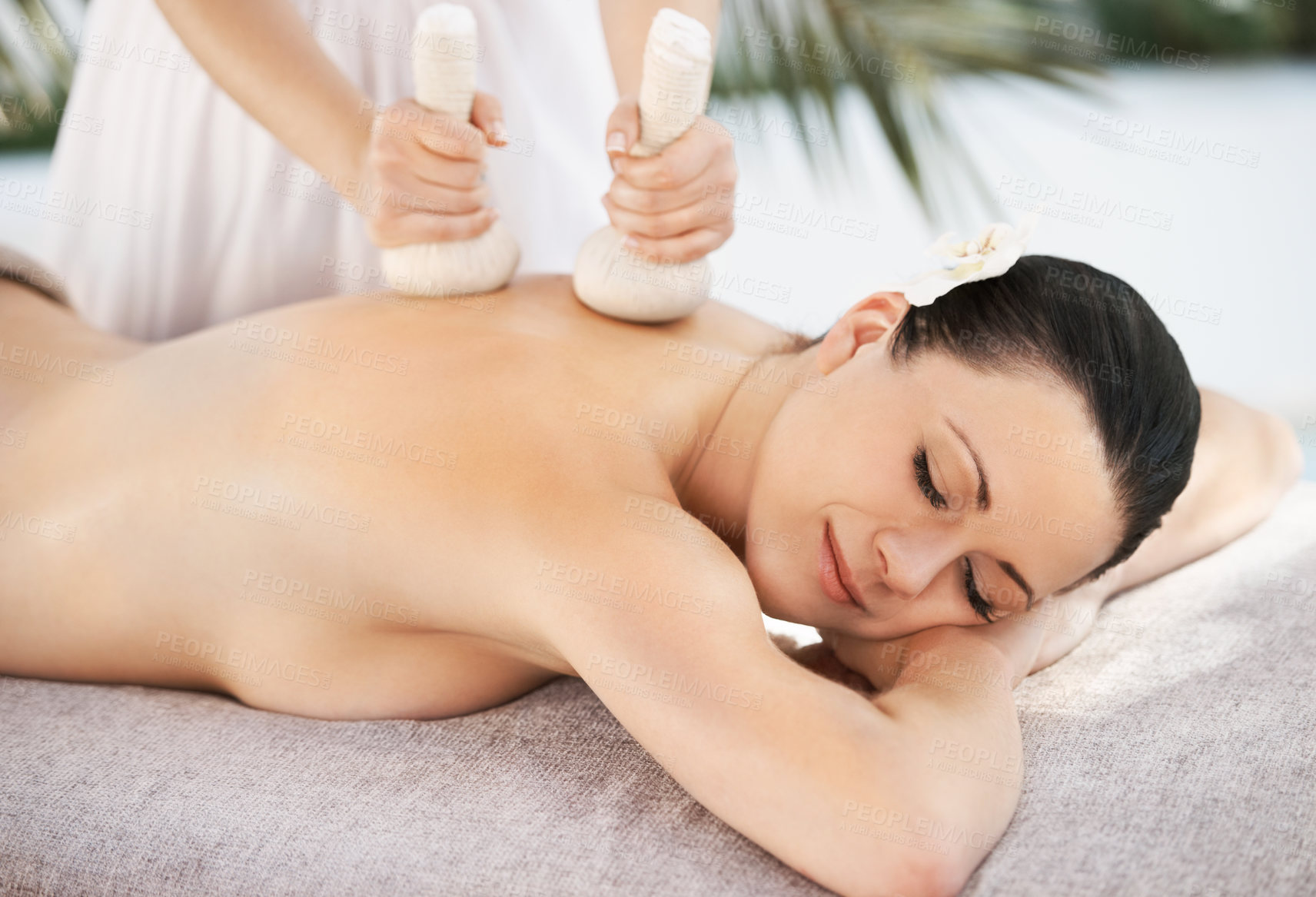 Buy stock photo Woman herbal ball and thai massage, spa and zen wellness with masseuse in outside resort on holiday. Body care, treatment and pressure with organic instrument, comfortable and eyes closed or relax