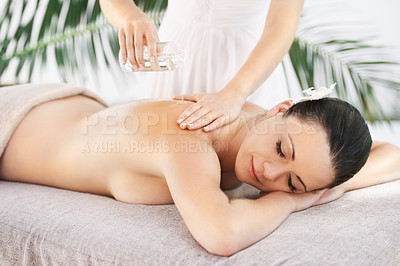 Buy stock photo A beautiful young woman enjoying a treatment from a massage therapist