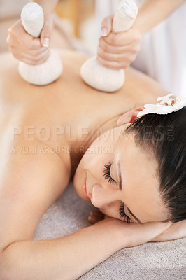 Buy stock photo Customer, herbal ball and thai massage, spa and zen wellness with masseuse in hotel resort on holiday. Body care, woman and pressure with organic instrument, comfortable and eyes closed or relax