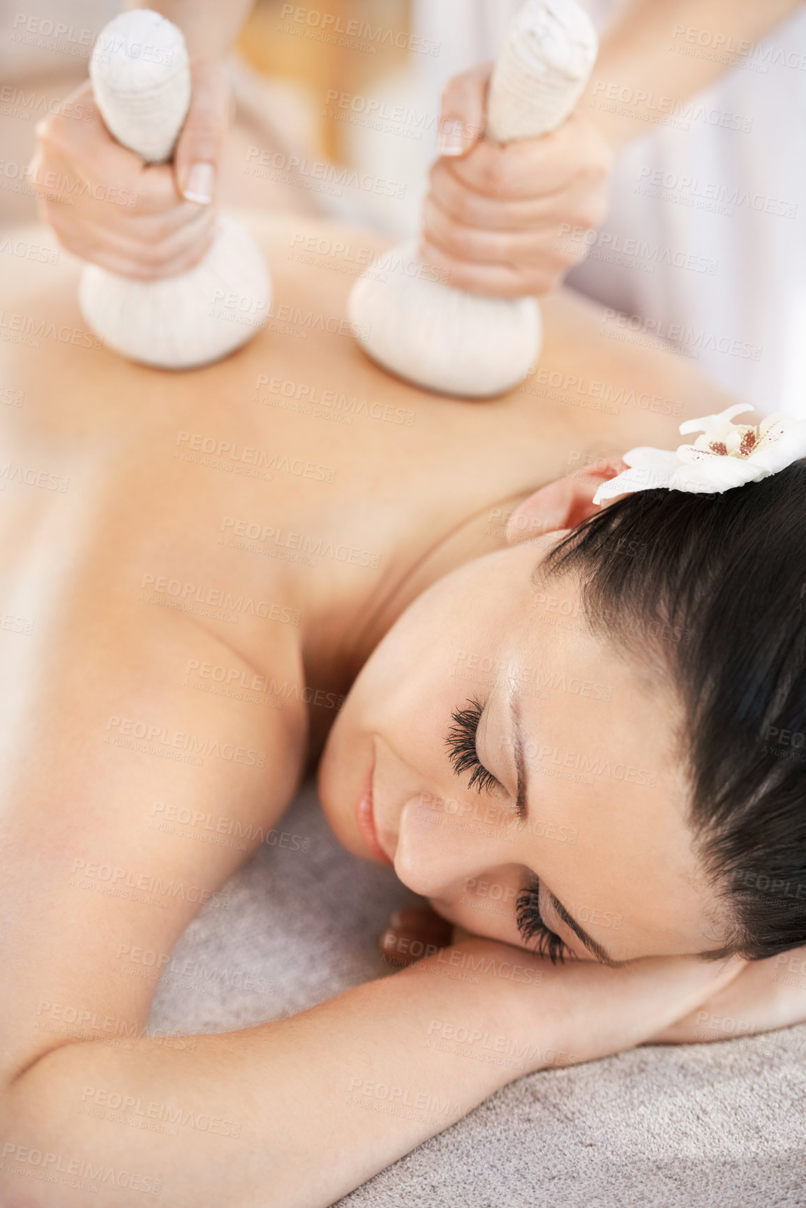 Buy stock photo Customer, herbal ball and thai massage, spa and zen wellness with masseuse in hotel resort on holiday. Body care, woman and pressure with organic instrument, comfortable and eyes closed or relax