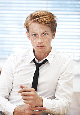 Buy stock photo Serious, portrait and businessman in office for internship in corporate legal career with confidence. Pride, professional and young male advocate from Ireland by desk for law company in workplace.