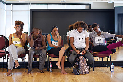 Buy stock photo Shot of a group of young dancers looking anxious while waiting for their dance auditions