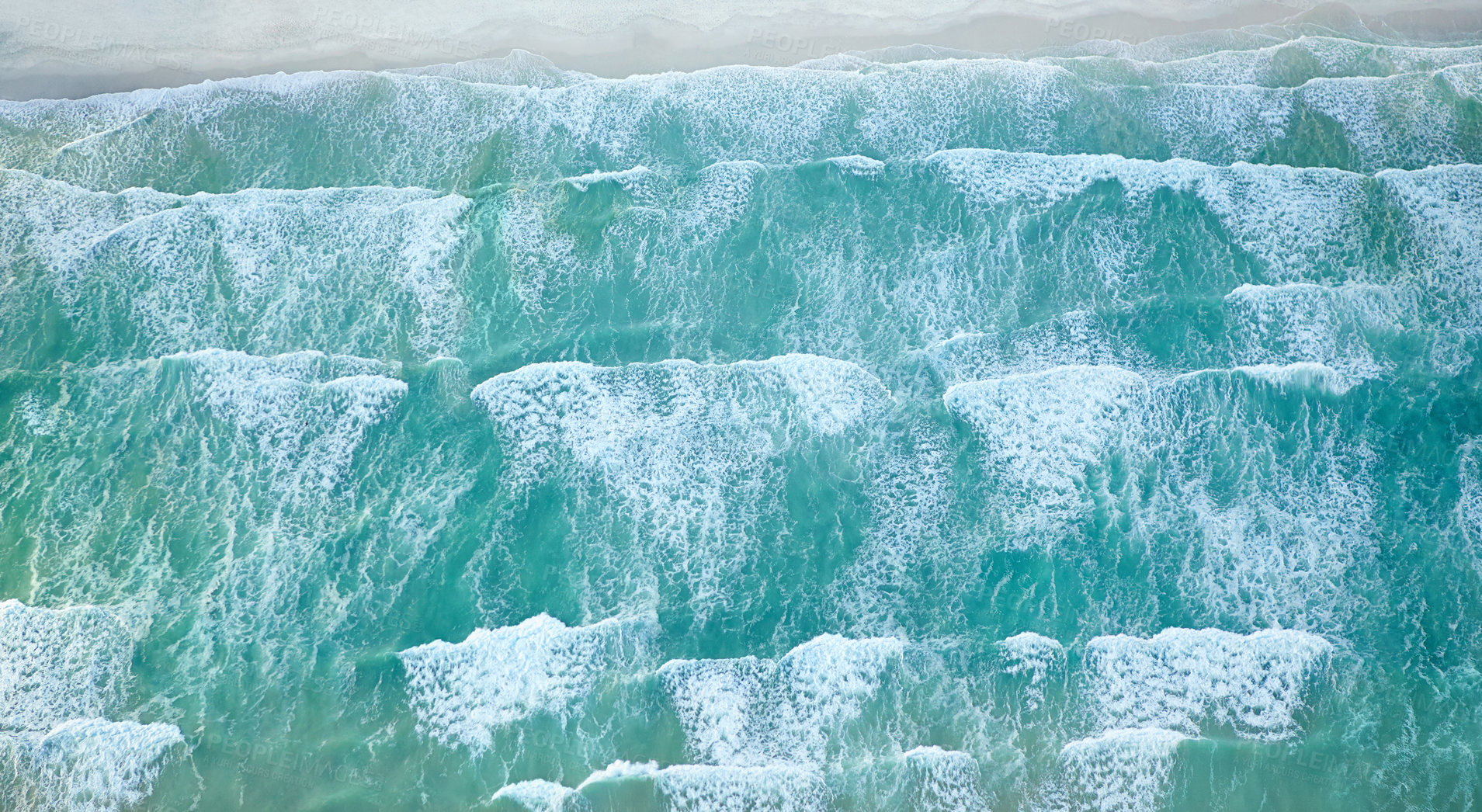 Buy stock photo Aerial view of ocean waves moving toward the shoreline