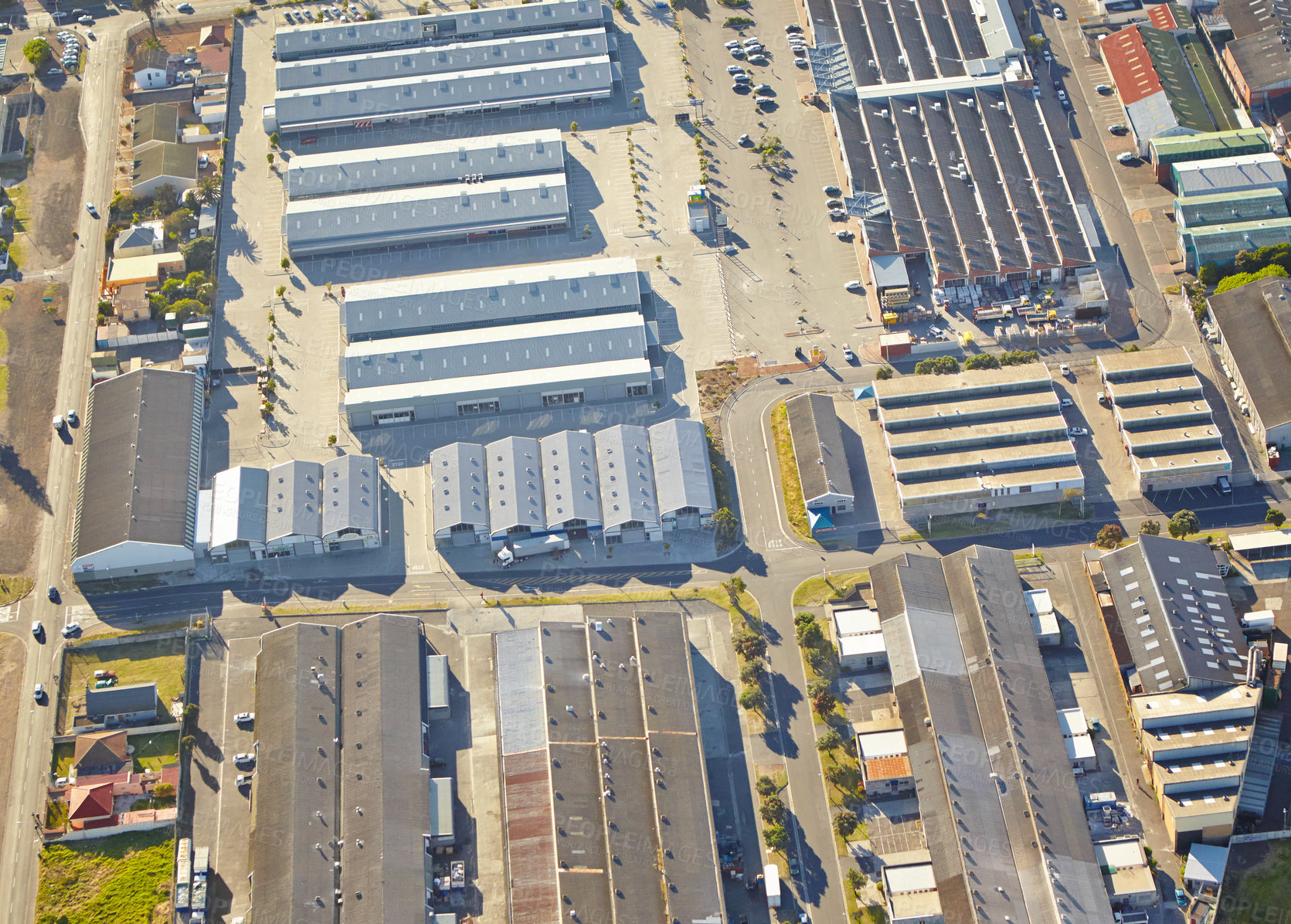 Buy stock photo Industrial, business park and aerial view of warehouse, factory and city district development. Urban, drone and manufacturing or production street for road, shipping and transportation for cargo