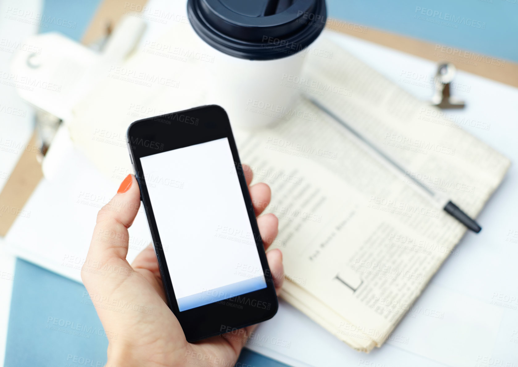 Buy stock photo Phone screen, top view and closeup of hands with mockup space, newspaper and coffee above. Smartphone, display and woman show information, advertising or marketing for business promotion in office