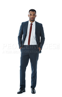 Buy stock photo A serious young businessman standing on a white background with his hands in his pockets