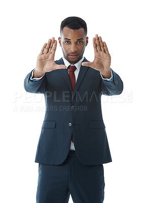 Buy stock photo A handsome young businessman using his hands to convey his vision