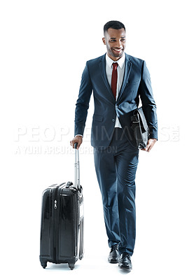Buy stock photo A handsome young african american businessman walking alongside his suitcase while isolated on white