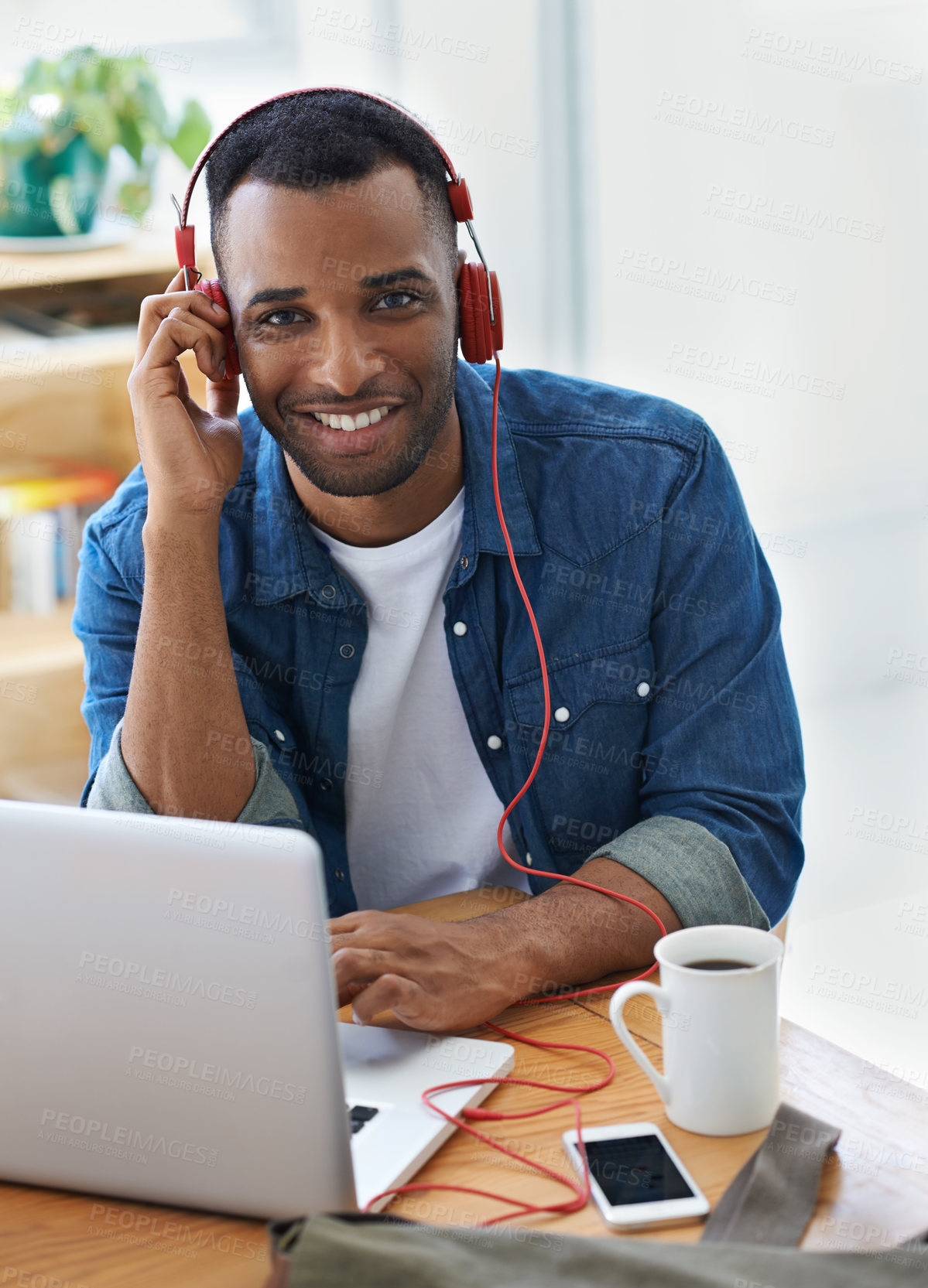 Buy stock photo A handsome casually dressed businessman working in his office