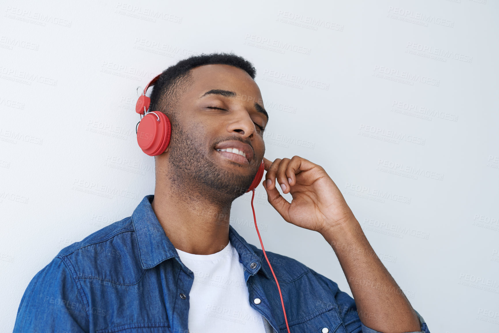 Buy stock photo Black man, headphones and listen to relax to song in studio, streaming music and white background. Male person, mockup space and connect to internet for sound, peace and calm podcast for meditation