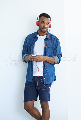 Buy stock photo A young african american man wearing a headphones and listening to music against a white background 