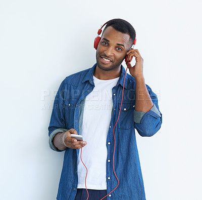 Buy stock photo A young african american man wearing a headphones and listening to music against a white background 