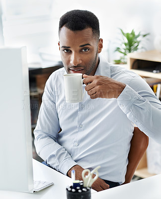 Buy stock photo A handsome young african american businessman sitting at his desk
