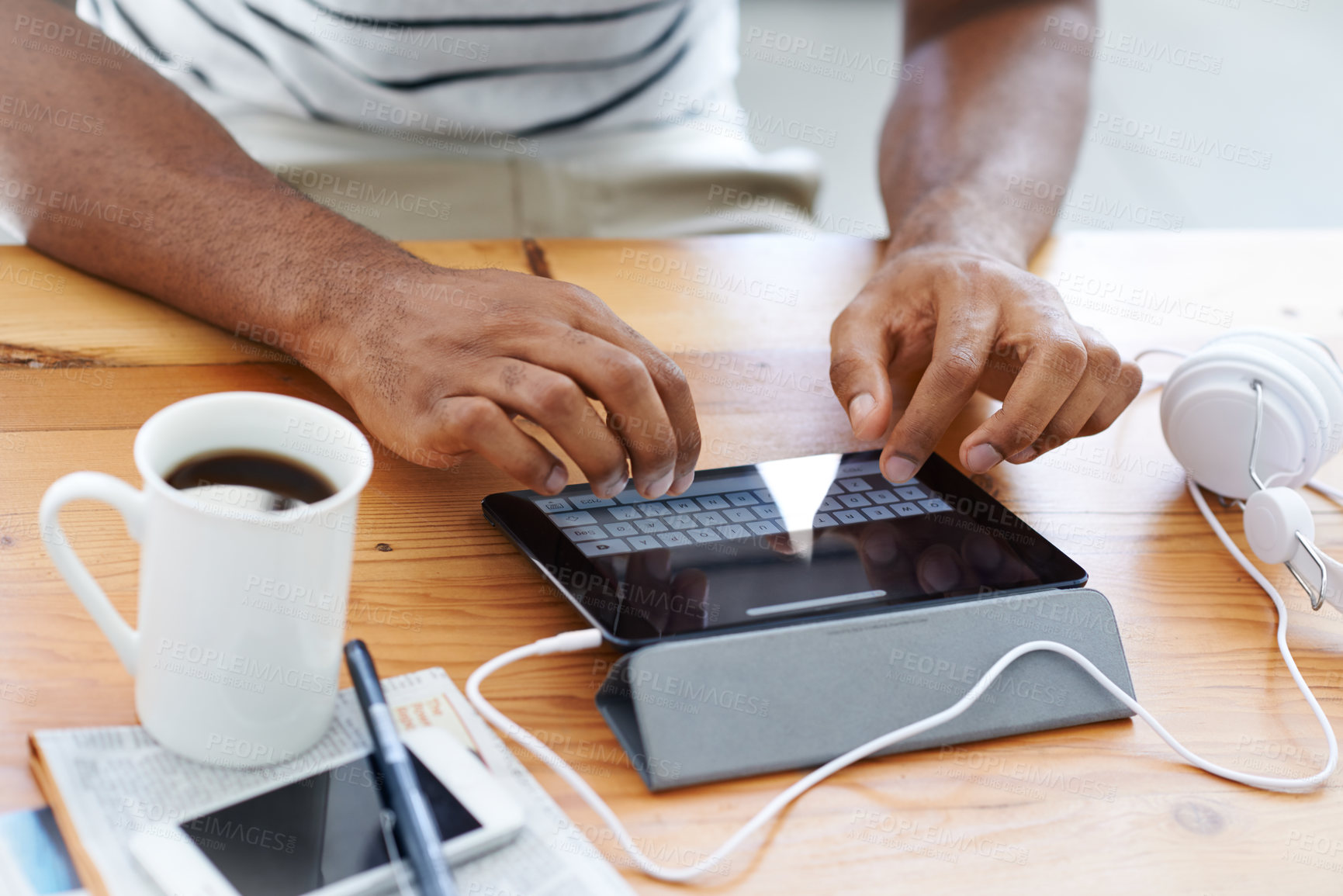 Buy stock photo Cropped view of an african american man working on a digital tablet at his desk