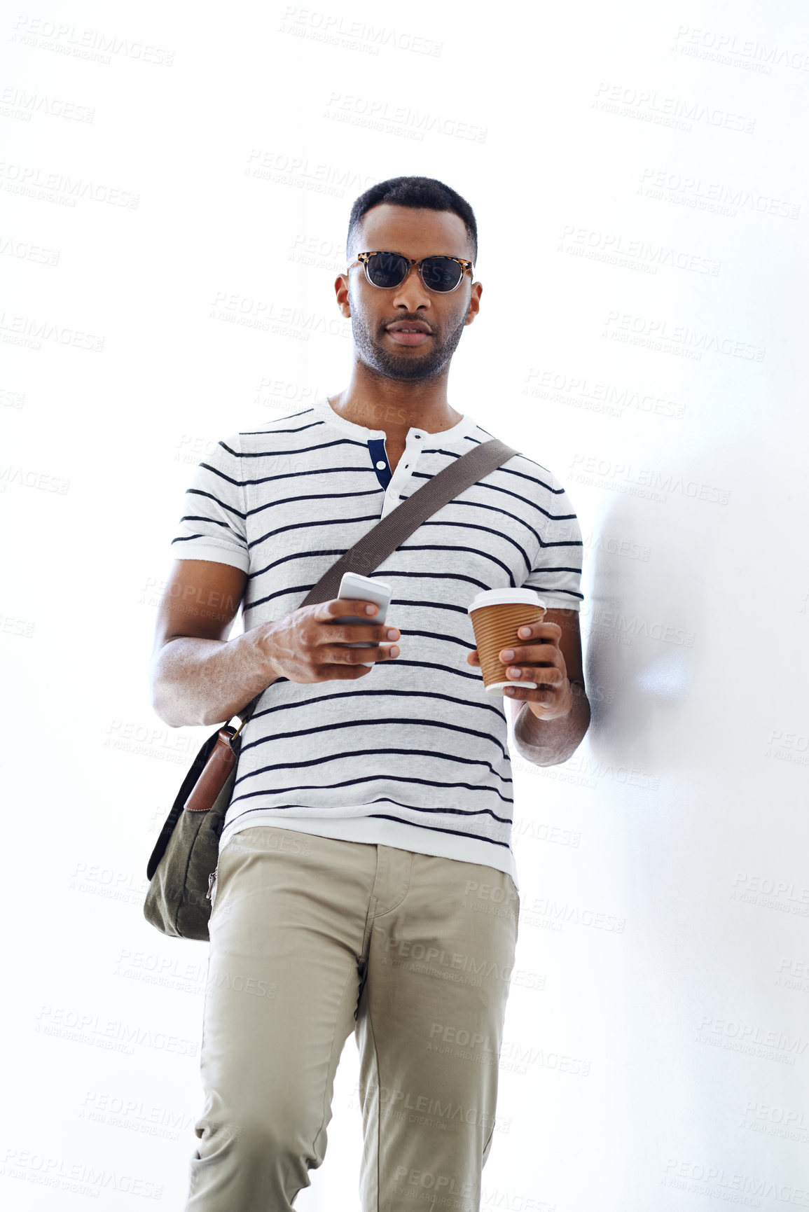 Buy stock photo Portrait, sunglasses and black man with fashion in studio with trendy outfit isolated on white background. Model, takeaway and African guy with smartphone, morning routine and cool commute clothes