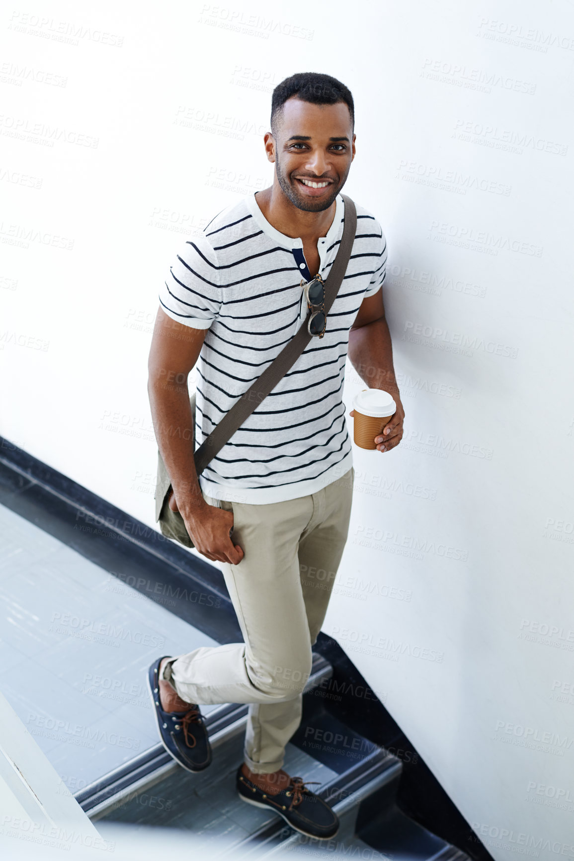 Buy stock photo Portrait, walking and black man on stairs with coffee, trendy outfit and smile for designer startup. Businessman, takeaway and African guy with creative fashion, morning routine and cool commute