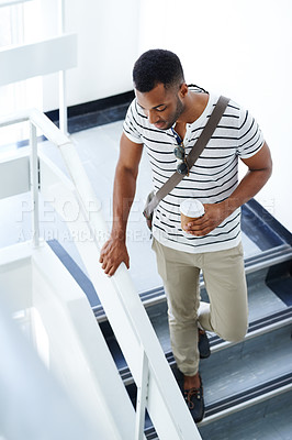 Buy stock photo Black man, coffee and college student walking on steps for break, lecture or next class in building. African male person, espresso and cup for beverage on campus in university to travel downstairs