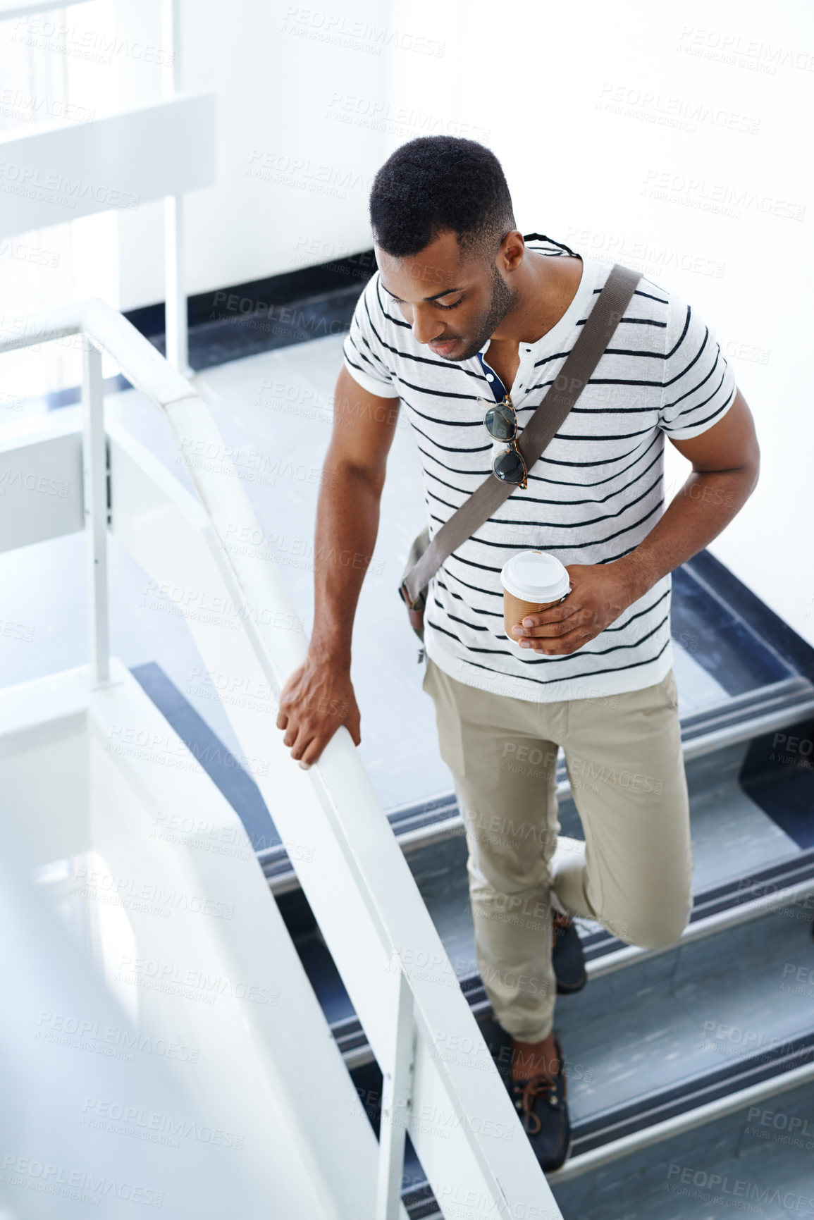 Buy stock photo Black man, coffee and college student walking on steps for break, lecture or next class in building. African male person, espresso and cup for beverage on campus in university to travel downstairs