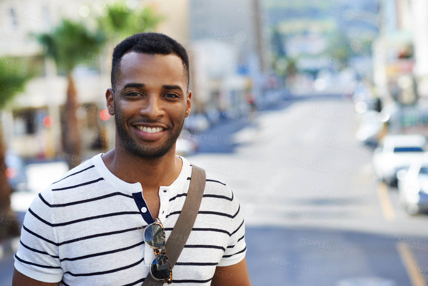 Buy stock photo A handsome african american businessman out in the city while on his way to work